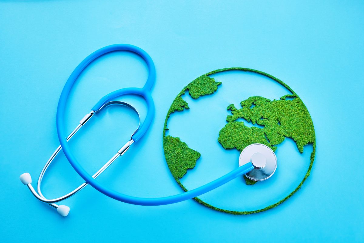 Blue graphic with the world illustrated as a globe in felt with a stethoscope laid at the side with the chest piece placed on the globe