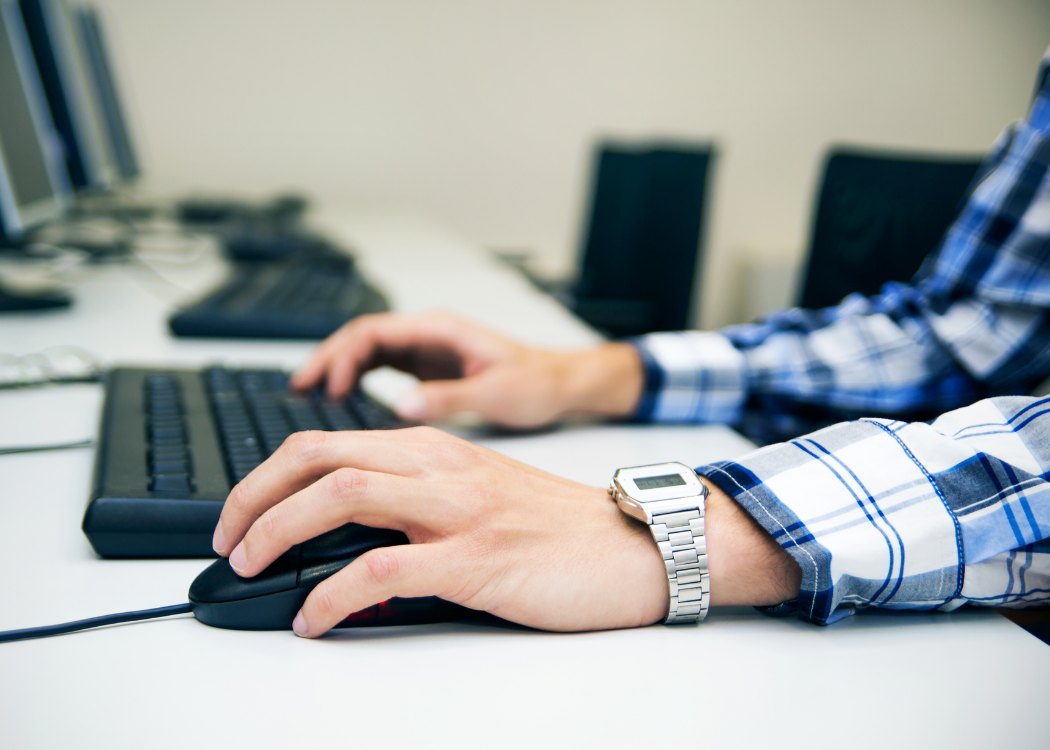 NLT Training offer online Test Only Renewal showing man sat in front of computer with keyboard and a mouse