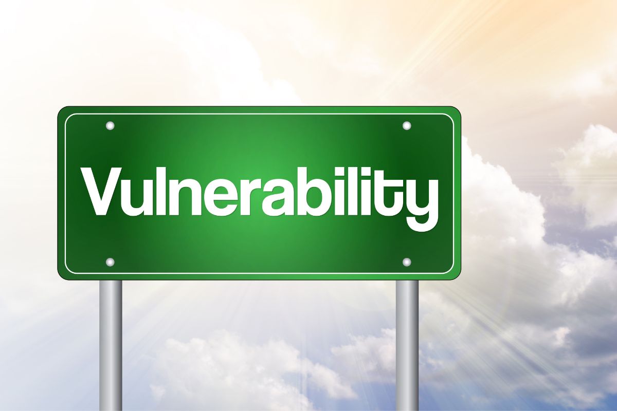 Green road sign displaying 'Vulnerability' in front of a cloud background